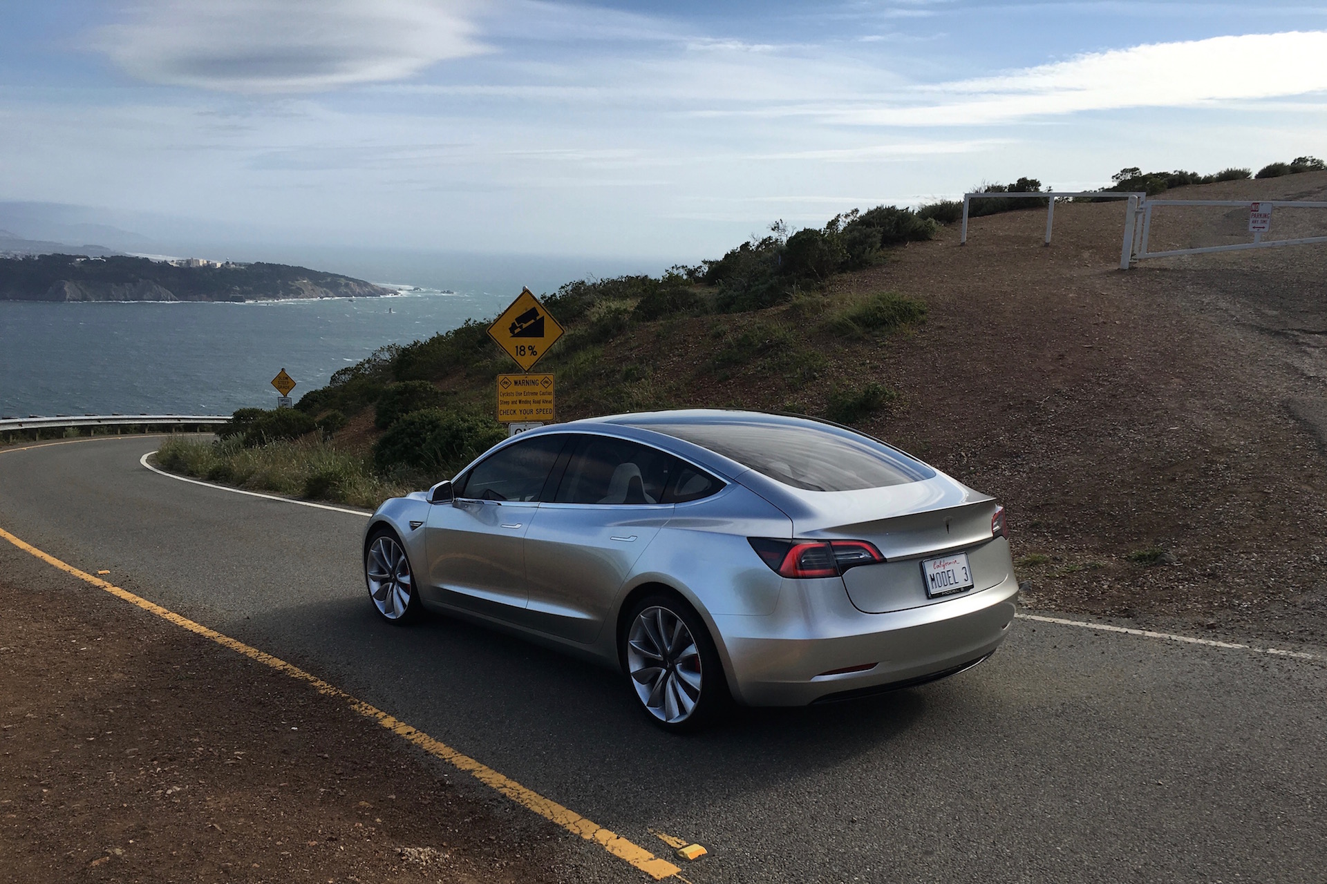 Silver Tesla Model 3 overlooking SF bay