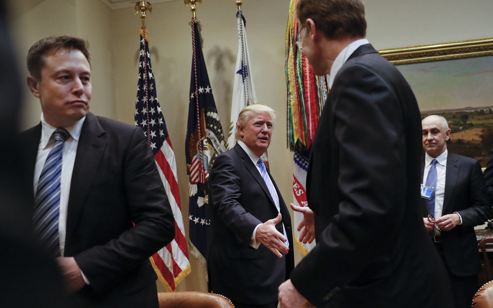 President Donald Trump greets Wendell P. Weeks, right, Chief Executive Officer of Corning, as he host breakfast with business leaders in the Roosevelt Room of the White House in Washington, Monday, Jan. 23, 2017. On the left of is Elon Musk, CEO of SpaceX and Tesla Motors. (AP Photo/Pablo Martinez Monsivais)