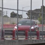 Red Tesla Model 3 at the Fremont Factory test track [Credit: Tesla Owners Club BE]