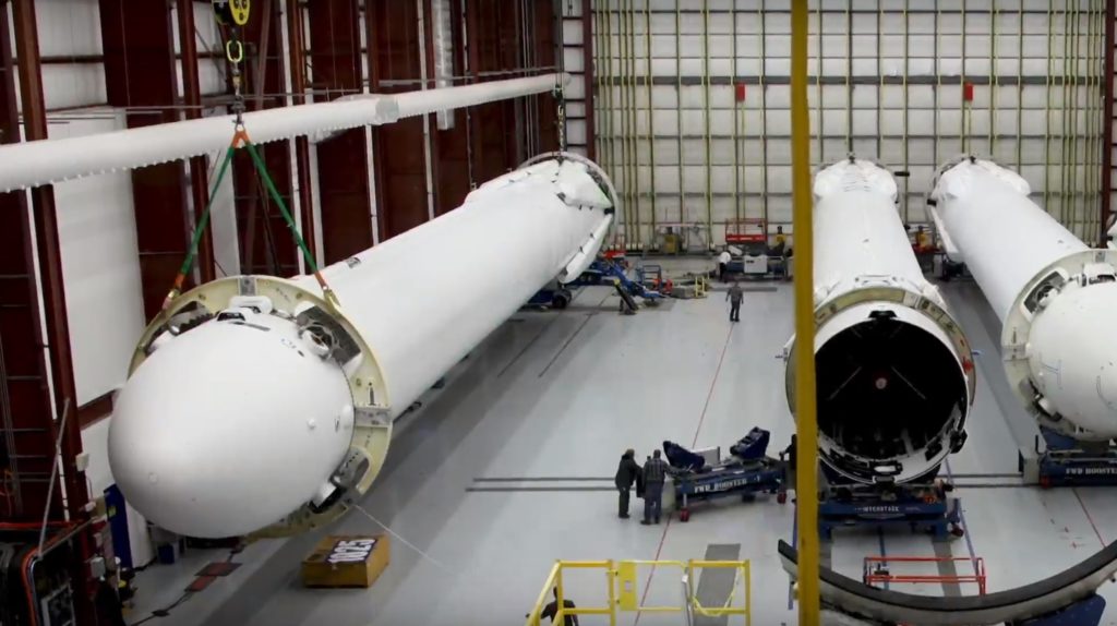 This photo shows the inside of 39A's integration facilities, and the aforementioned crane can be seen in action moving one of Falcon Heavy's side cores. (SpaceX)