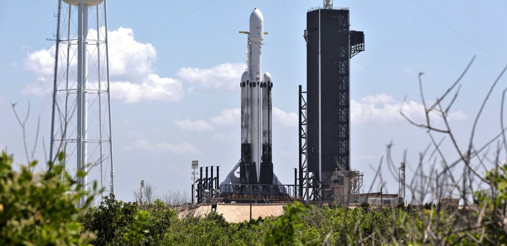 Falcon Heavy Flight 3 made use of both flight-proven side boosters and a new center core. Note the scorched landing legs and sooty exteriors. (SpaceX)